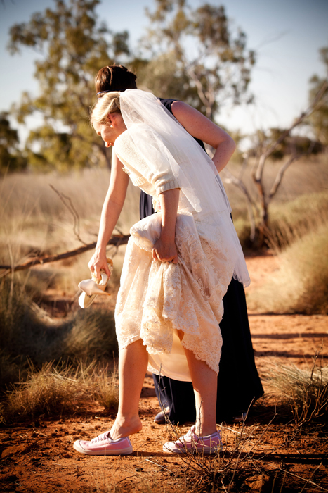 bride with bridesmaid in the red dust and dirt