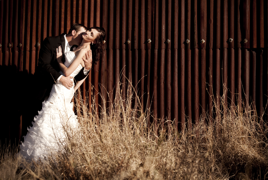 wedding couple in front of old shed