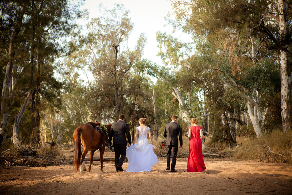 bridal party and horse in river bed, rural wedding