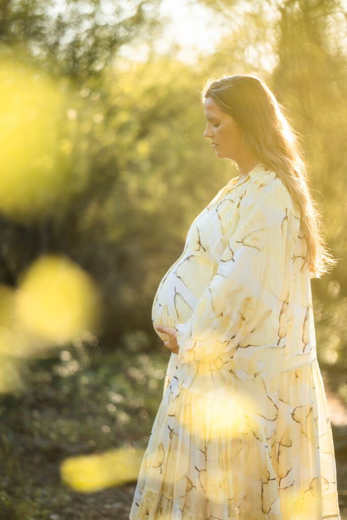 Backlit maternity portrait with beautiful vintage lens flare