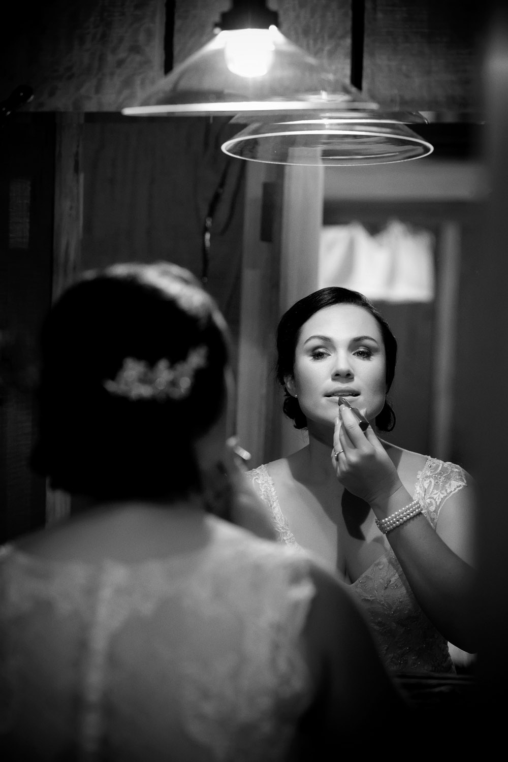 bride applying makeup