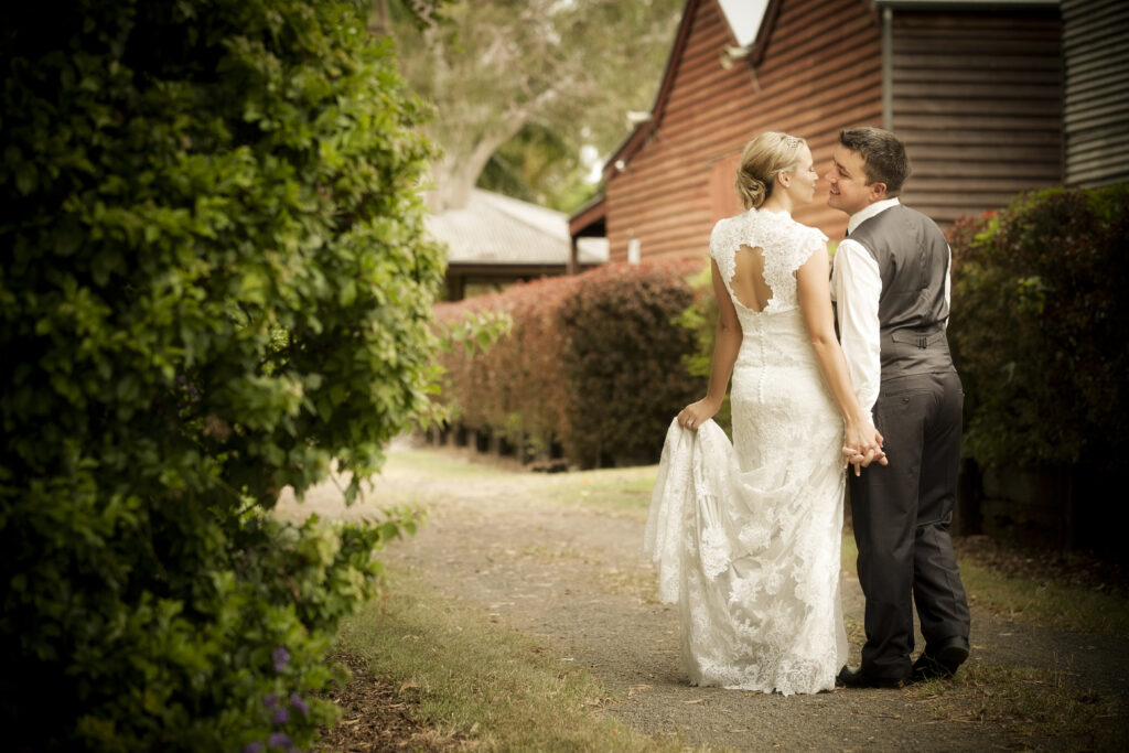 Editorial wedding photography of a bride and groom holding hands