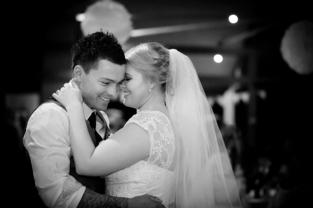 Bride and groom dancing together at their wedding celebration
