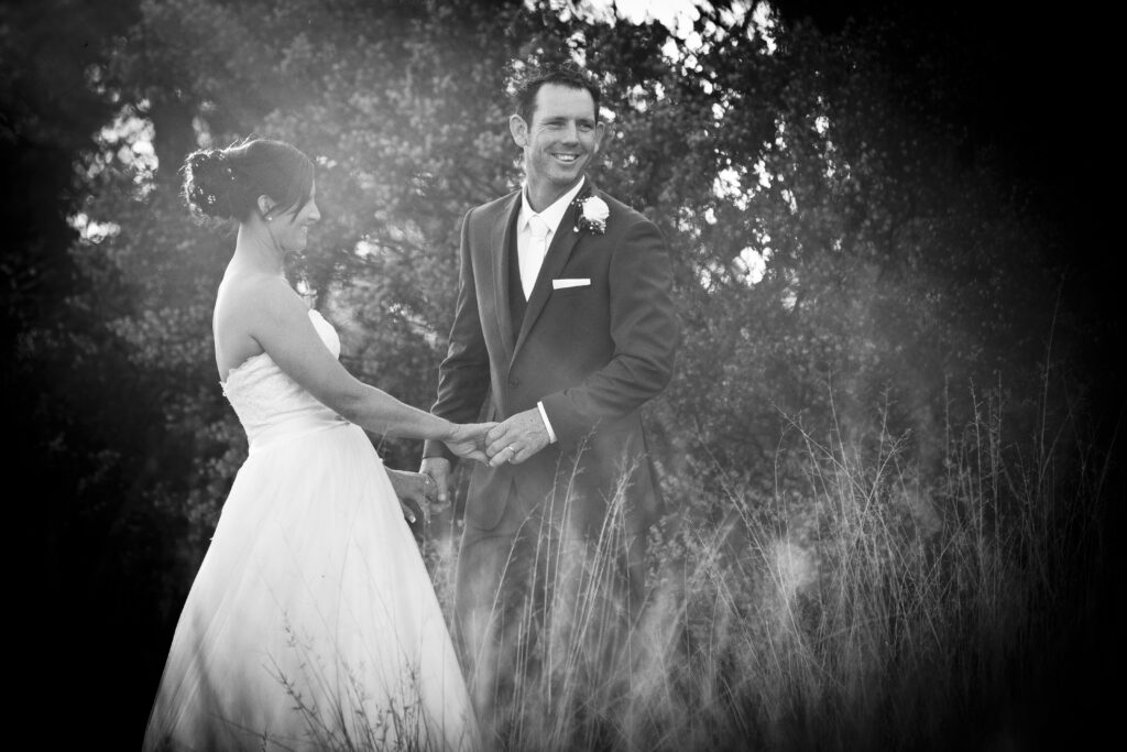 Bride and groom laughing together during their wedding portraits