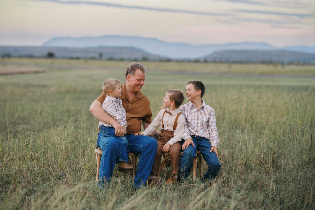 Grandfather and his grandsons photographed together in a field